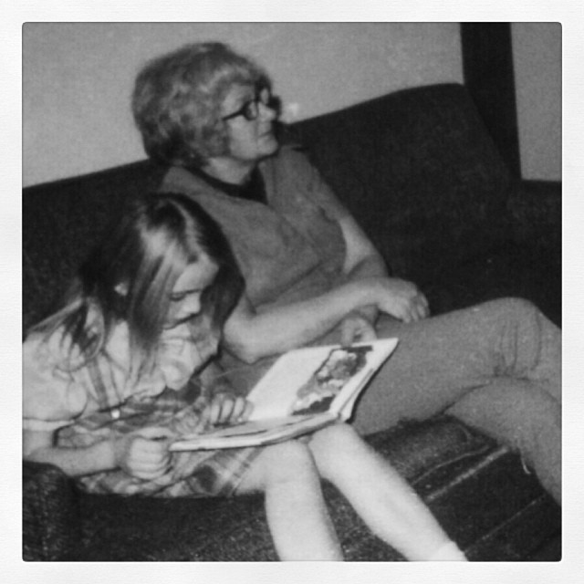 Girl reading book with grandmother