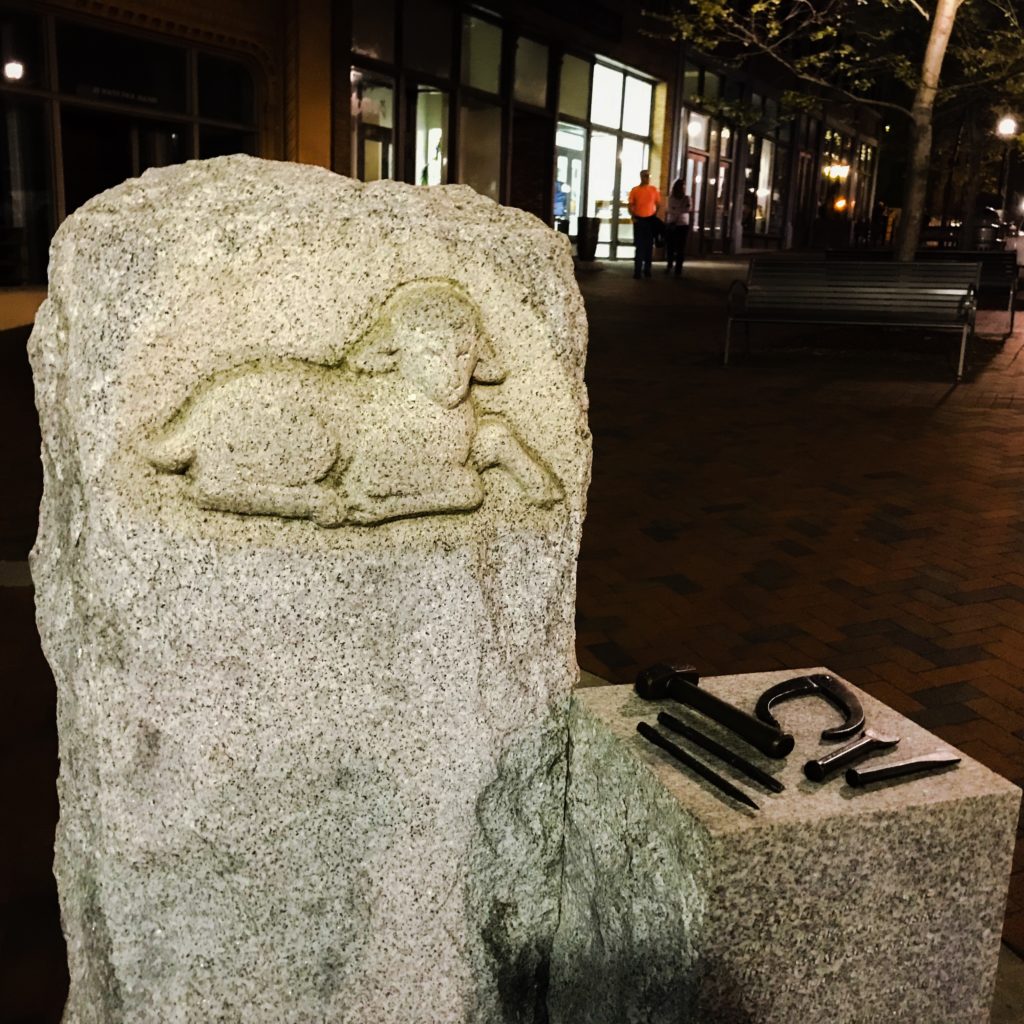 Sheep and tools monument in downtown Asheville, NC at night