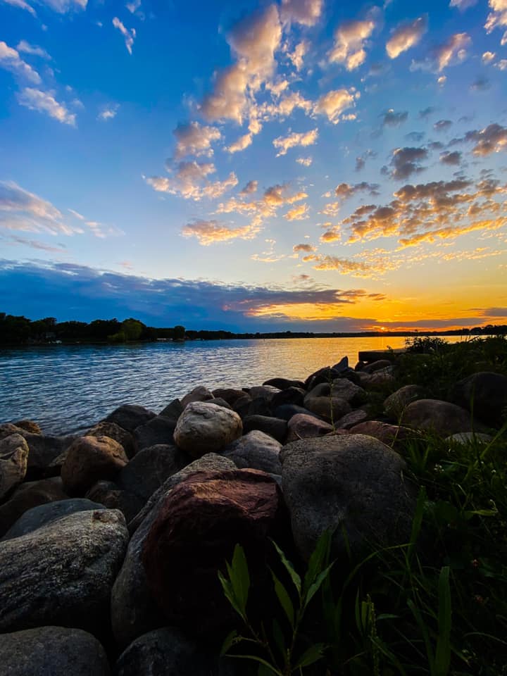 Sunset on lake with rocky shoreline