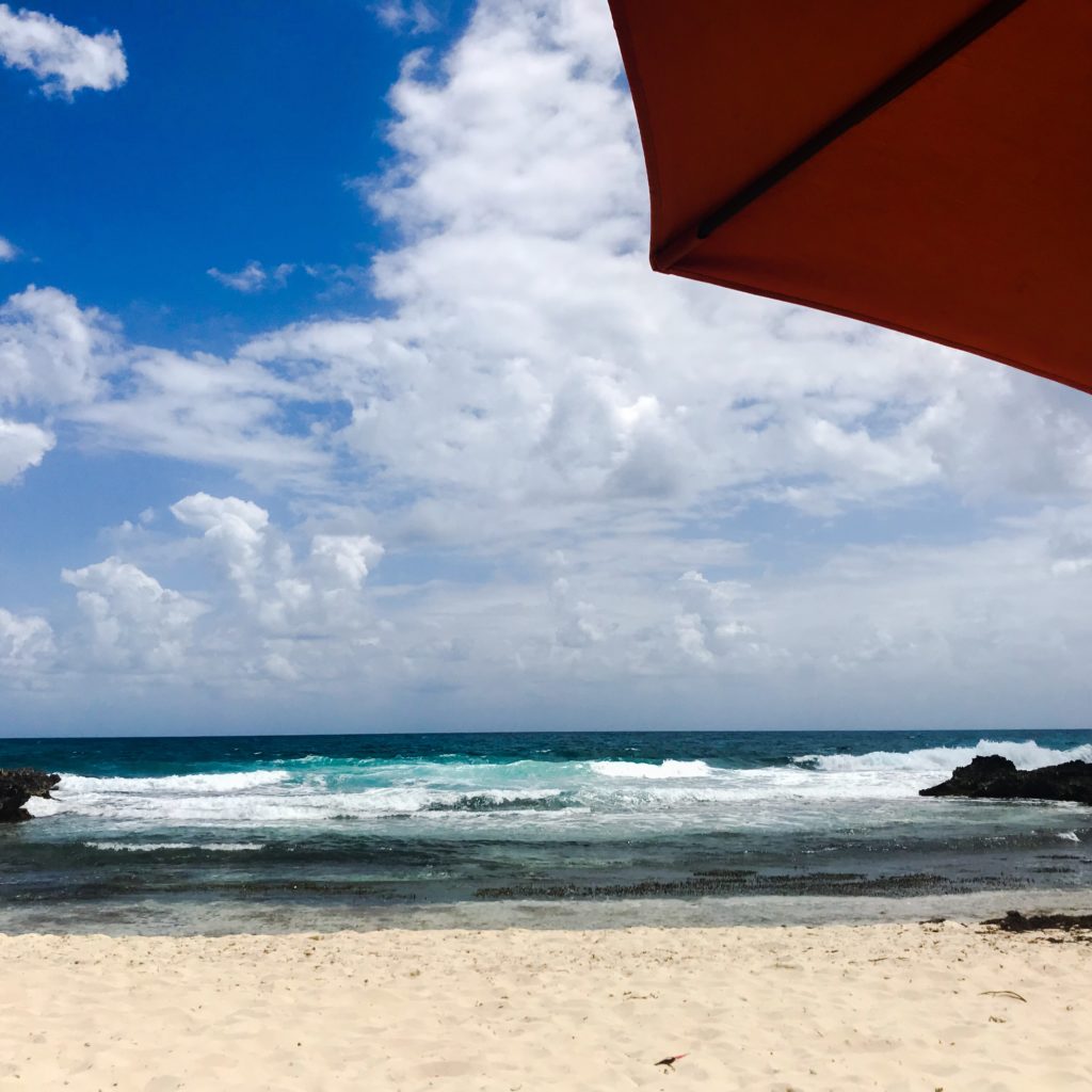 Beach umbrella on beach; Isla Mujeres, Mexico