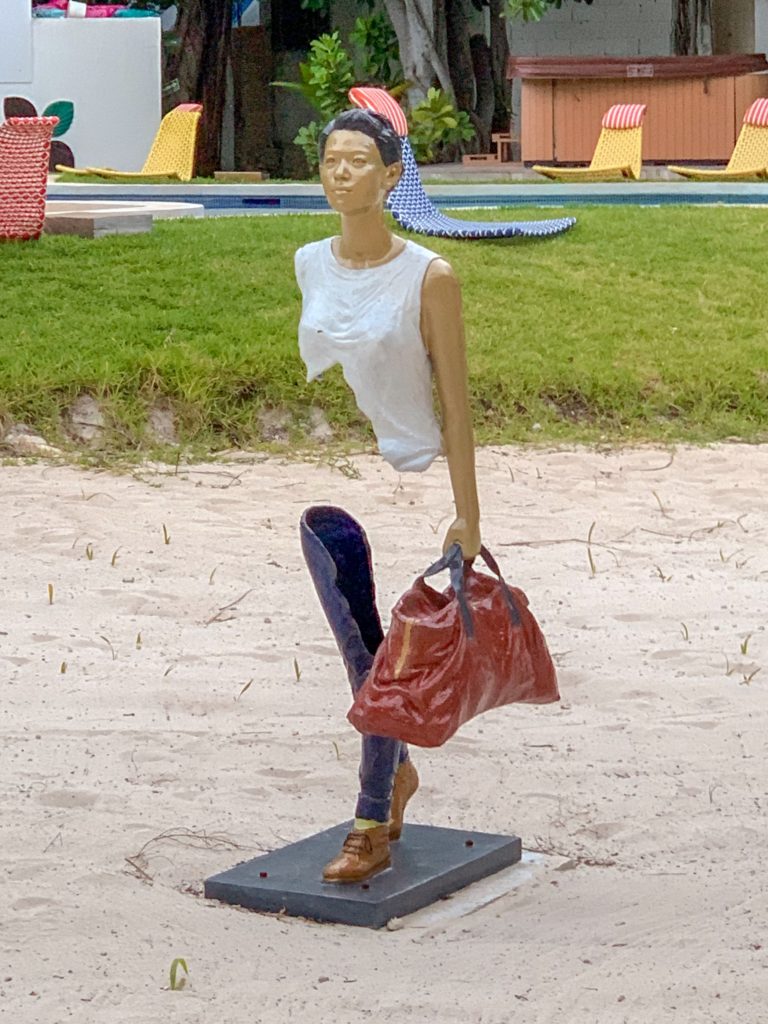 Female sculpture holding a hobo bag