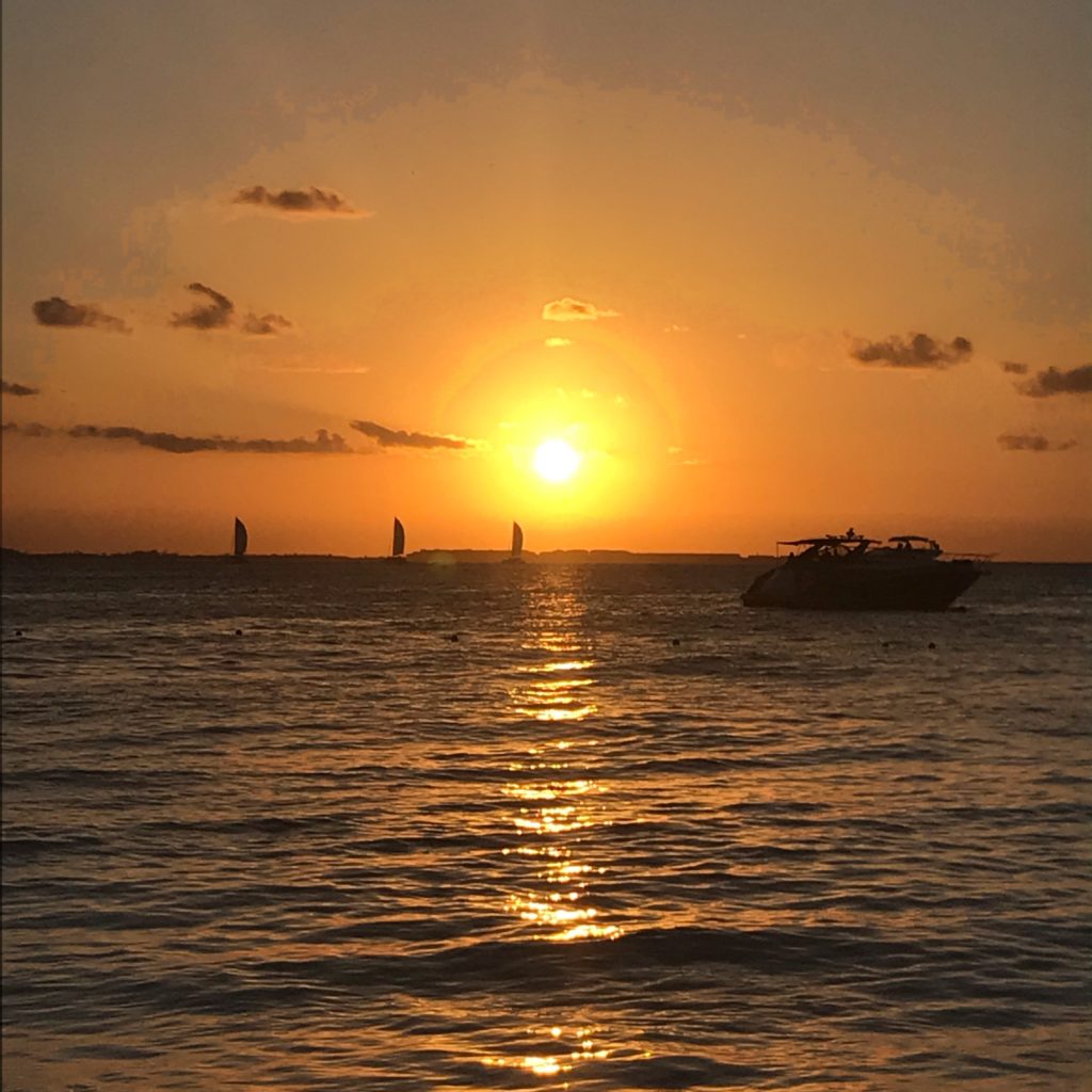 Sunset on North Beach - Isla Mujeres, Mexico; boats in the water 