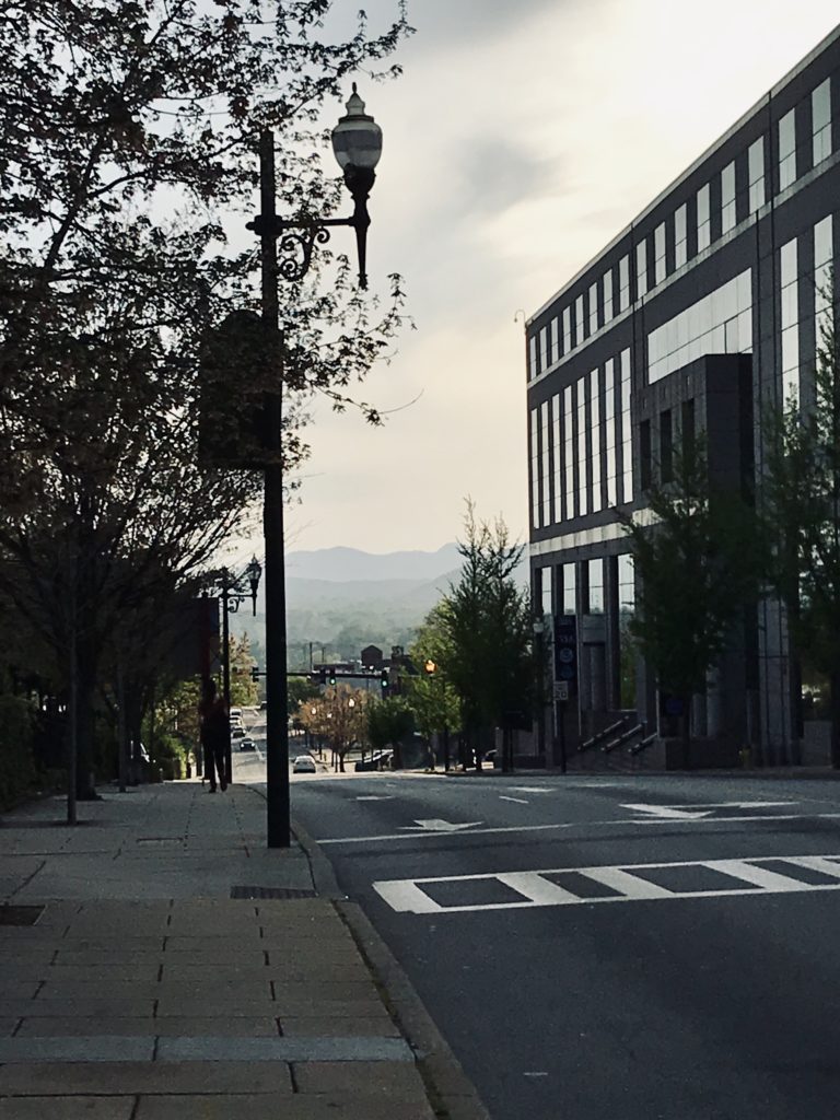 Downtown Asheville, N.C. city street with mountains in the background