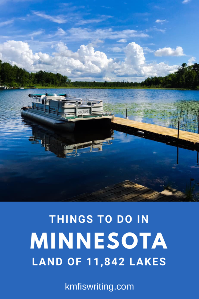 Pontoon boat on Hand Lake, Minnesota with a dock and lilypads. A local's travel guide to the top things to do in Minnesota the land of 10,000 lakes and more. 
