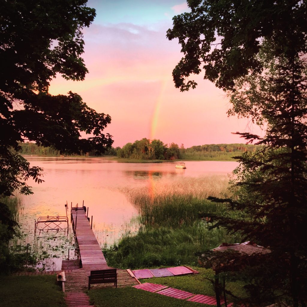 Sunset and rainbow over a lake Baby Lake, Minnesota