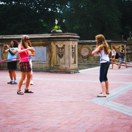 Woman and girl hula hooping in Central Park 