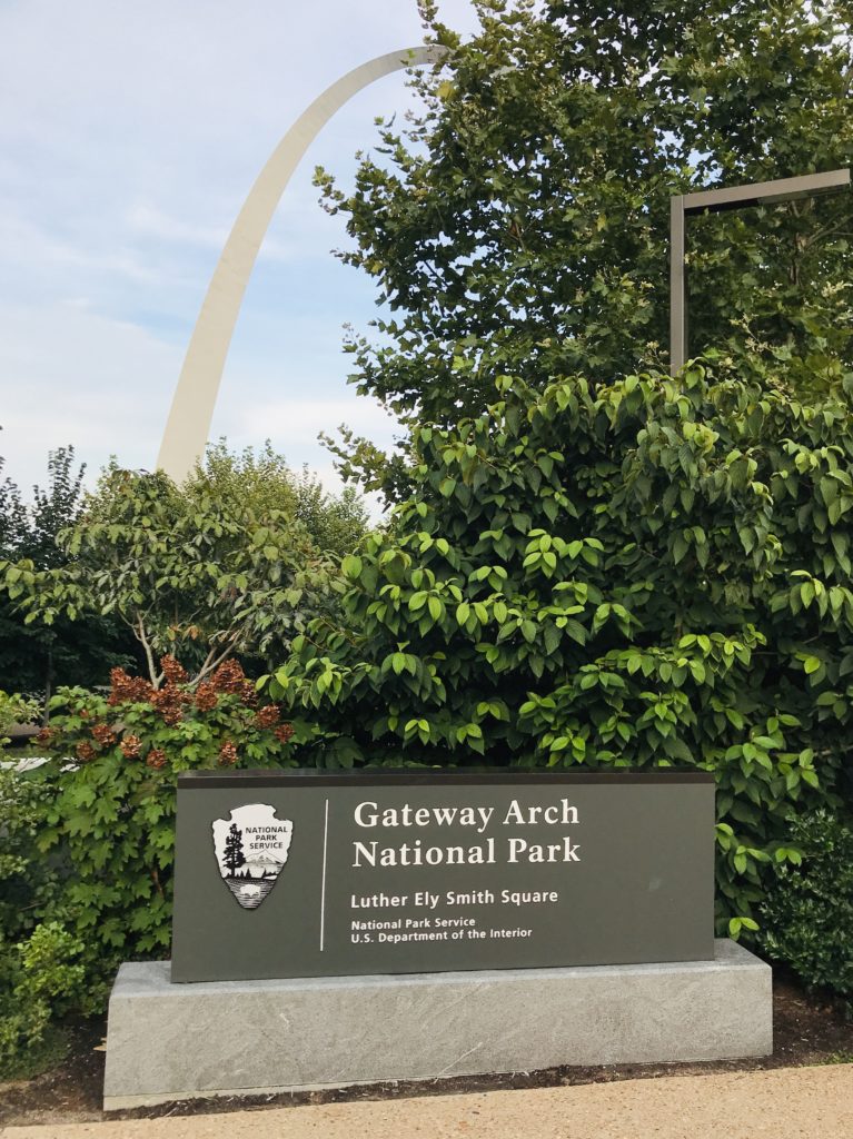 Gateway Arch in St. Louis with a sign