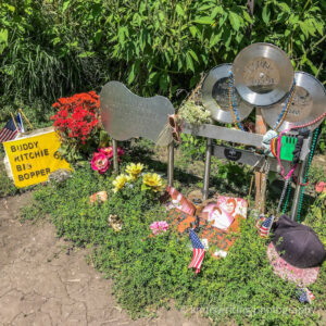 Memorial at Buddy Holly Crash site in corn field with memorial markers for Buddy Holly, Ritchie Valens and The Big Bopper