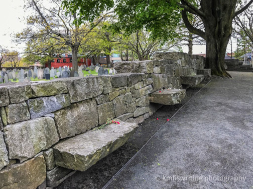 Salem witch trial memorial wall at The Burying Point Cemetery