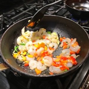 Frying pan with vegetables and shrimp for pad Thai recipe