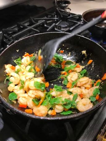 Stirring shrimp and Thai basil