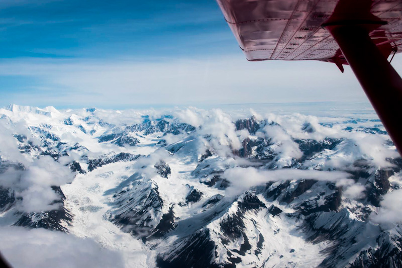 Aerial shot from airplane of snowcapped mountains in Alaska
