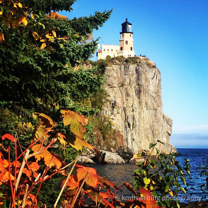 Lighthouse overlooking Lake Superior with fall colors leaves