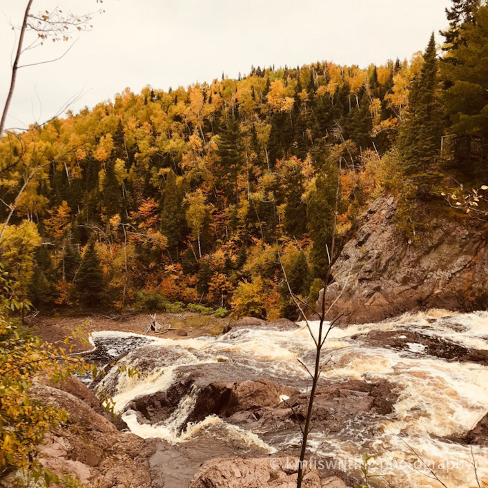 Top of a waterfall overlooking fall colors foliage trees