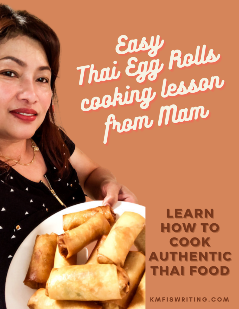 Thai woman holding platter of egg rolls