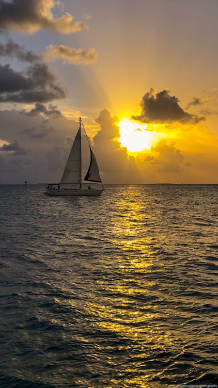 Sailboat on water with sunset