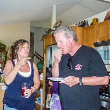 Woman pointing finger at man eating
