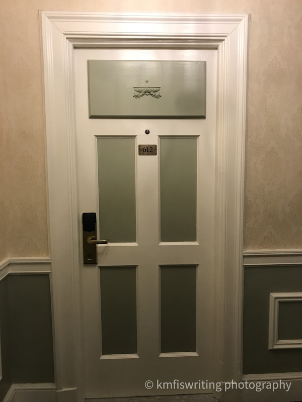 Green and white paneled door room 612