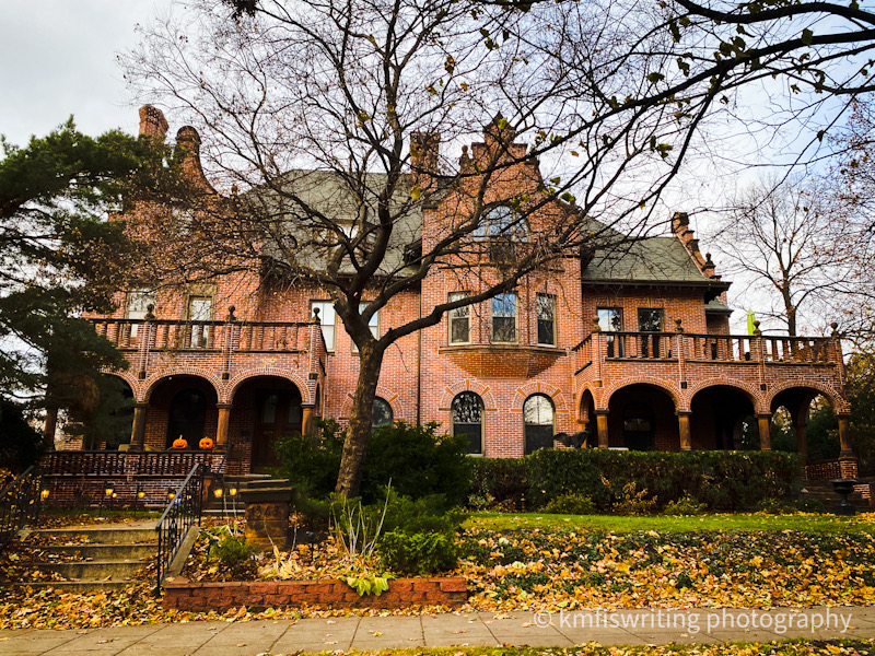 Historic mansion with fall leaves and Halloween decorations