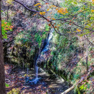 Waterfall in the woods with fall colors