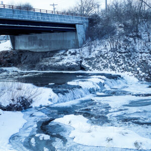 Frozen waterfalls under a bridge