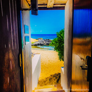 Open door leading to beach and ocean