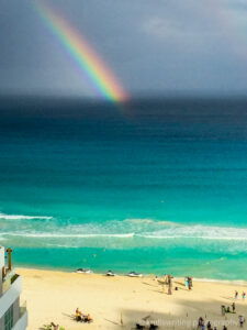 Rainbow and ocean with wedding on beach