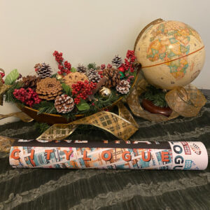poster in a tube with a globe and Christmas floral arrangement