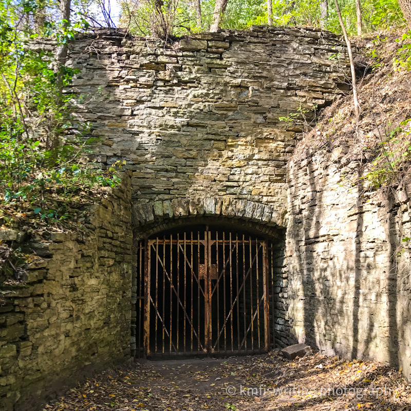 Cave in limestone rock with locked gate
