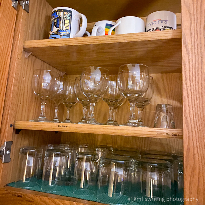 Open cupboard of glasses and cups