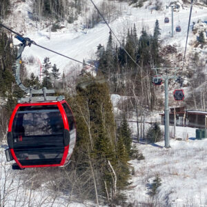 Empty gondola car at ski resort with winter scene
