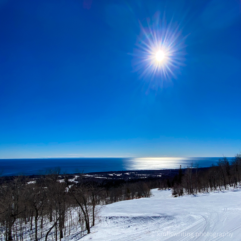 Bright sun and blue sky with blue lake in the winter