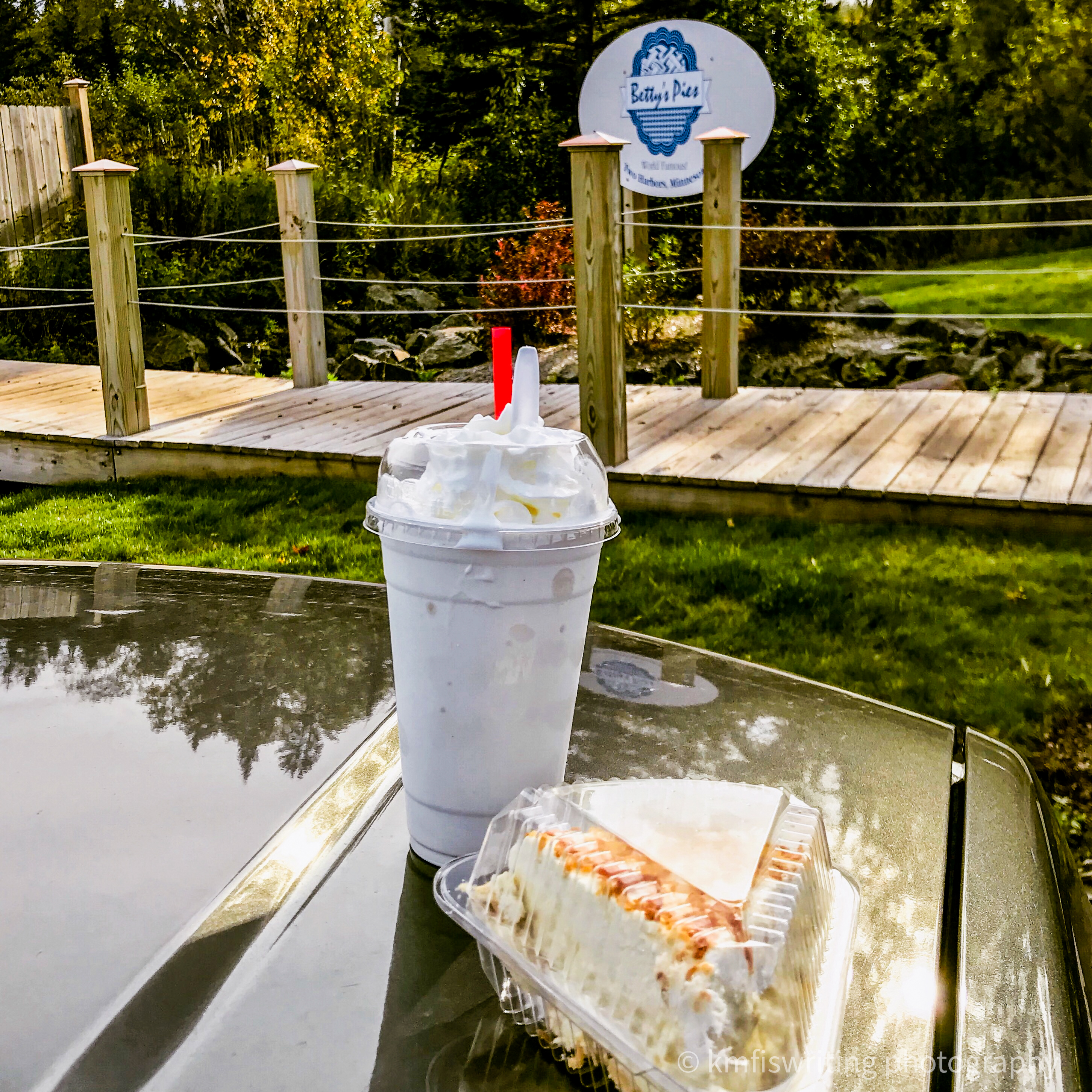 Milkshake and slice of pie sitting on car hood