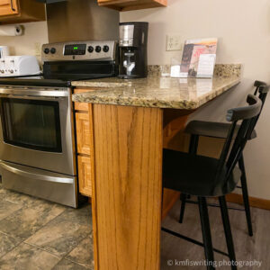 Kitchen counter bar with bar stools and stove