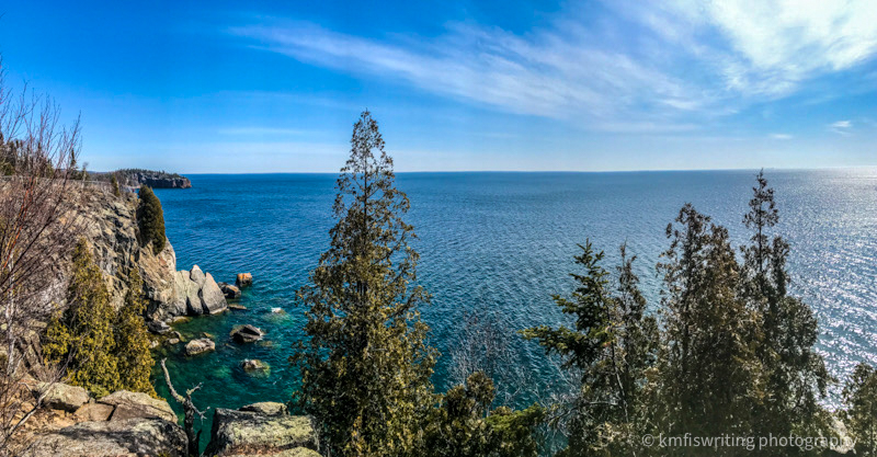 Panoramic view of a blue lake with trees and cliffs on Minnesota's North Shore