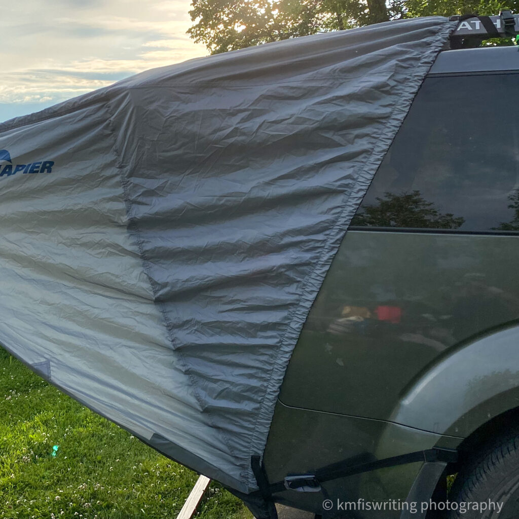 SUV tent attached to wheel well and roof rack