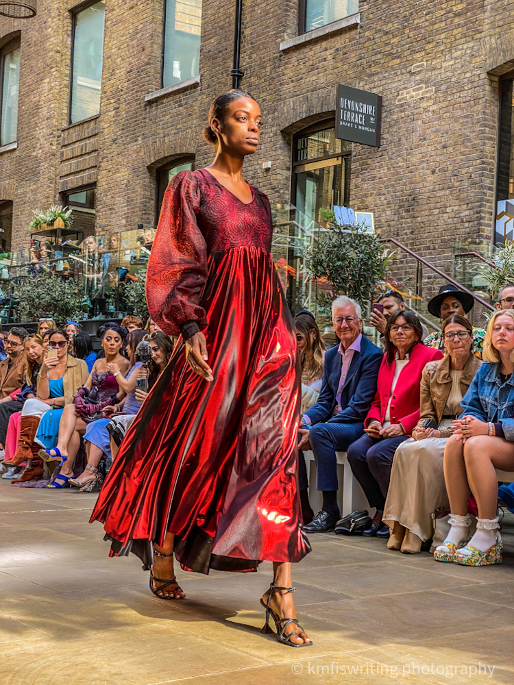 London Fashion Week woman wearing red dress on runway